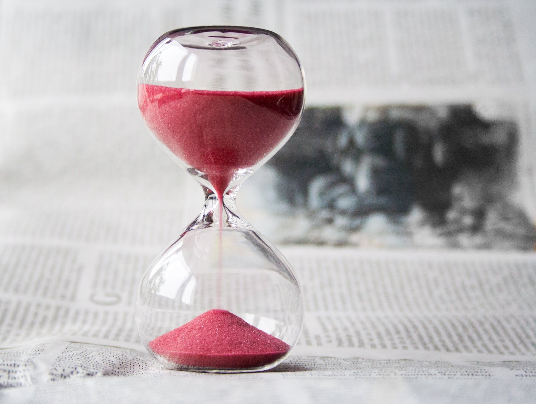 clear hourglass with red sand grainer