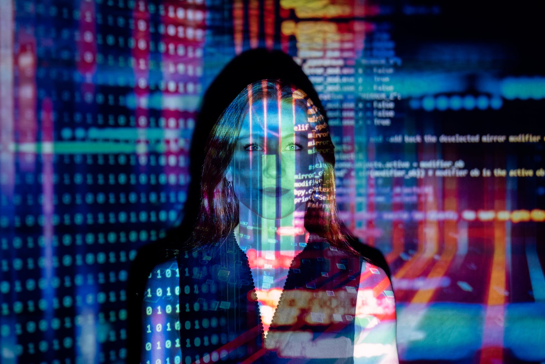 code projected over woman to signify Information Management