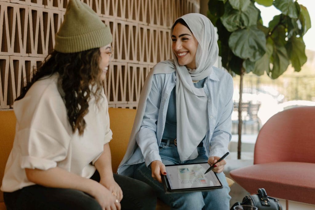 Two women discussing business goals.